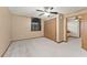 View of a large bedroom with wood-look closet doors, and an interesting arched window at 3310 Tall Timber Dr, Orlando, FL 32812