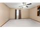 Spacious bedroom featuring a ceiling fan and a window with privacy curtains at 3310 Tall Timber Dr, Orlando, FL 32812