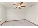 Bright bedroom with a ceiling fan, neutral carpet, and wood trim at 3310 Tall Timber Dr, Orlando, FL 32812