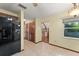 Dining area with tile floors with a view of hall storage and a black refrigerator at 3310 Tall Timber Dr, Orlando, FL 32812