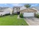 Charming two-story home with brick accents, attached garage, and a well-maintained lawn at 3310 Tall Timber Dr, Orlando, FL 32812