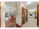 Hallway featuring wood and tile flooring leading to the living and dining areas at 3310 Tall Timber Dr, Orlando, FL 32812