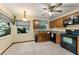 Well-lit kitchen with tile flooring, oak cabinets, and black appliances at 3310 Tall Timber Dr, Orlando, FL 32812