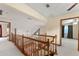 Upstairs landing area with views of the living room and natural light at 3310 Tall Timber Dr, Orlando, FL 32812