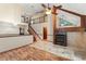 Cozy living room featuring a grand fireplace, high ceilings, and wood floors at 3310 Tall Timber Dr, Orlando, FL 32812