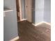 Bedroom featuring a stylish wood-look tile floor and soothing, light blue walls at 5084 Downing St # 2, Orlando, FL 32839