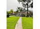 Well-maintained community pool surrounded by lush landscaping and a wrought iron fence at 5084 Downing St # 2, Orlando, FL 32839