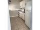 Traditional-style kitchen featuring white appliances and tile flooring at 5084 Downing St # 2, Orlando, FL 32839
