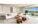 Bright living room with a large white sofa, area rug, and view of the outdoor patio at 5277 Bowspirit Way, St Cloud, FL 34771