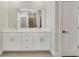 Bathroom vanity features double sinks, white cabinetry, and a large mirror at 109 Violet Ct, Kissimmee, FL 34759