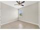 A bedroom features a ceiling fan, neutral walls, and a window view at 109 Violet Ct, Kissimmee, FL 34759