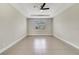 A spacious bedroom features a ceiling fan, neutral walls, and a window view at 109 Violet Ct, Kissimmee, FL 34759