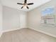 Bright bedroom with ceiling fan, tile flooring, neutral paint, and window with horizontal blinds at 109 Violet Ct, Kissimmee, FL 34759