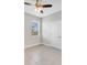 A compact bedroom features a ceiling fan, neutral walls and a window at 109 Violet Ct, Kissimmee, FL 34759