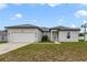 Charming one-story home featuring a two-car garage and well-manicured lawn at 109 Violet Ct, Kissimmee, FL 34759