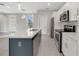 Open kitchen with island, stainless steel appliances, and eat-in area at 109 Violet Ct, Kissimmee, FL 34759