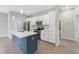 Well-equipped kitchen featuring stainless steel appliances and blue island at 109 Violet Ct, Kissimmee, FL 34759