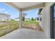 Covered patio area overlooking a spacious backyard with nearby houses and grass at 109 Violet Ct, Kissimmee, FL 34759