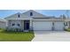 Charming single-story home with a two-car garage, covered porch, and nicely landscaped front yard at 1985 Walnut Creek Dr, Kissimmee, FL 34744