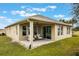 Covered patio featuring an outdoor seating area and view of the backyard at 1985 Walnut Creek Dr, Kissimmee, FL 34744