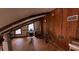 Attic featuring wood paneling, exposed beams, and a desk with a chair by the window at 209 Fairway Dr # 209, Longwood, FL 32779