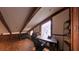 Attic space featuring wood floors, exposed beams, and a desk with a chair by the window at 209 Fairway Dr # 209, Longwood, FL 32779