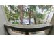 Balcony view with mature trees overlooking parking area, showing privacy and convenient access for residents at 209 Fairway Dr # 209, Longwood, FL 32779