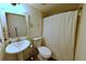 Bathroom featuring a pedestal sink, toilet and shower with curtain at 209 Fairway Dr # 209, Longwood, FL 32779