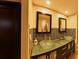 Double vanity bathroom featuring vessel sinks, glass counter, dark cabinets and tile backsplash at 209 Fairway Dr # 209, Longwood, FL 32779