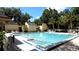 Community pool with steps, seating, and ample deck space and lounge chairs surrounding the area at 209 Fairway Dr # 209, Longwood, FL 32779