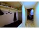 Hallway with built-in shelving and hooks, leading to a living area with comfortable seating at 209 Fairway Dr # 209, Longwood, FL 32779
