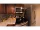 Updated kitchen featuring stainless steel appliances, granite countertops, and wooden cabinets at 209 Fairway Dr # 209, Longwood, FL 32779