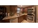Updated kitchen featuring stainless steel appliances, granite countertops, and wooden cabinets at 209 Fairway Dr # 209, Longwood, FL 32779