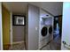 Bright laundry area with white front load washer and dryer on a tiled floor at 209 Fairway Dr # 209, Longwood, FL 32779