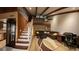 Open concept living area with staircase, loft, exposed beams and comfortable seating, creating a welcoming atmosphere at 209 Fairway Dr # 209, Longwood, FL 32779