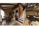 Bright and open living space connecting dining area, kitchen, and stairs, with exposed wooden beams at 209 Fairway Dr # 209, Longwood, FL 32779