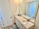 Bathroom features double sinks, solid surface countertops, wood-look flooring and a large mirror at 3117 Caribbean Soul Dr, Kissimmee, FL 34747
