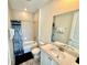 Well-maintained bathroom featuring tiled walls, a shower-tub combo, and a sink with a vanity at 3117 Caribbean Soul Dr, Kissimmee, FL 34747