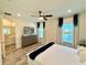 Primary bedroom showcases a flat screen television, a ceiling fan and wood-look tile flooring at 3117 Caribbean Soul Dr, Kissimmee, FL 34747