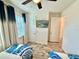 Guest room features wood-look flooring, a ceiling fan and a flat screen television at 3117 Caribbean Soul Dr, Kissimmee, FL 34747