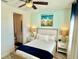 Bedroom with ensuite bathroom features wood-look flooring, cool paint tones and ample natural light at 3117 Caribbean Soul Dr, Kissimmee, FL 34747