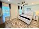 Well-lit primary bedroom features a ceiling fan, wood-look flooring and a view of the water at 3117 Caribbean Soul Dr, Kissimmee, FL 34747