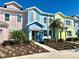 Charming colorful townhomes with well-maintained landscaping, enhancing curb appeal and comfort at 3117 Caribbean Soul Dr, Kissimmee, FL 34747