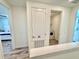 Hallway featuring the entrance to a bedroom and the laundry, making it easier to manage daily living at 3117 Caribbean Soul Dr, Kissimmee, FL 34747