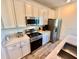 Modern kitchen with stainless steel appliances, white cabinets, and quartz countertops at 3117 Caribbean Soul Dr, Kissimmee, FL 34747