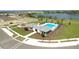 Aerial view of community pool, clubhouse, playground and lake at 3549 Salvia Ct, Tavares, FL 32778