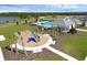 Scenic aerial view of the pool, clubhouse, and playground in a well-maintained community at 3549 Salvia Ct, Tavares, FL 32778