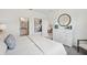 Bright bedroom featuring a dresser with a round mirror, and an ensuite bathroom at 3549 Salvia Ct, Tavares, FL 32778