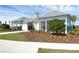 Beautiful white clubhouse exterior with covered veranda and well-maintained landscaping at 3549 Salvia Ct, Tavares, FL 32778