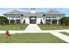 Charming white clubhouse with covered veranda and manicured lawn area at 3549 Salvia Ct, Tavares, FL 32778